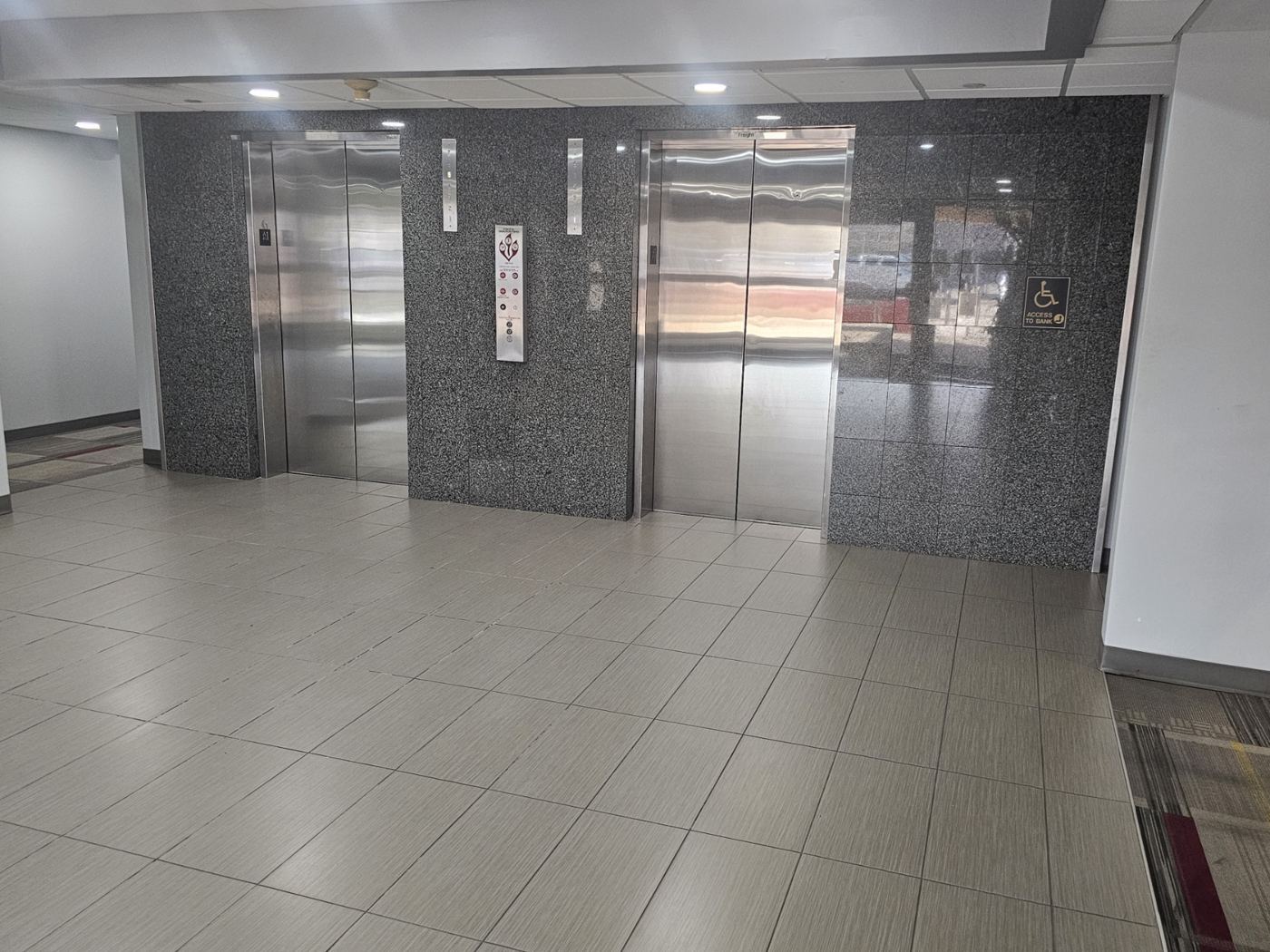 Two elevator doors in the ground-floor lobby