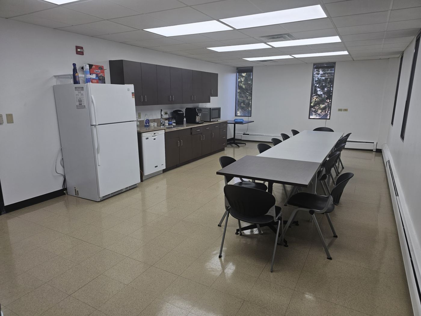 Floor 4 kitchen with cabinets, refrigerator, and a long table