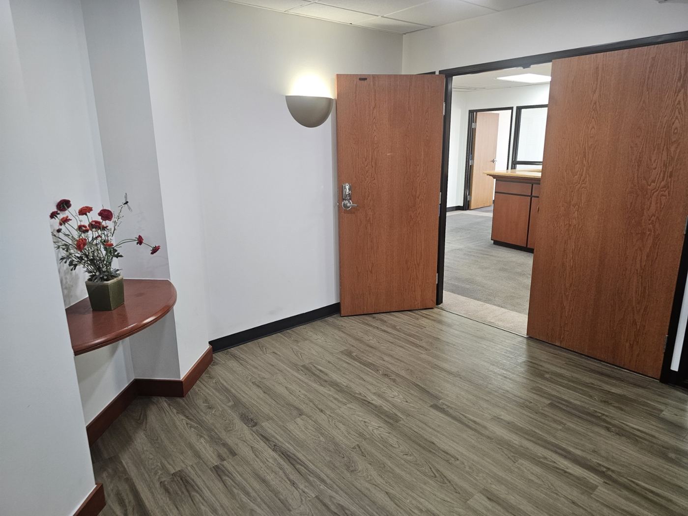 Floor 6 elevator lobby with wood double doors into the suite