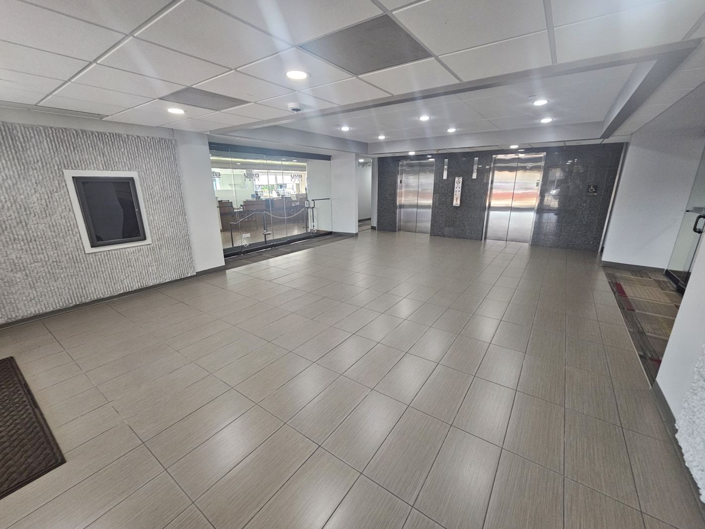Ground-floor lobby with tile floor and glass entry